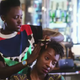 Lupita Nyong’o braids a friend’s hair in a short film shot for Vogue magazine
Screenshot